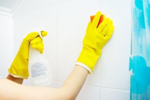 Cleaner polishing glass surfaces in a Docklands apartment